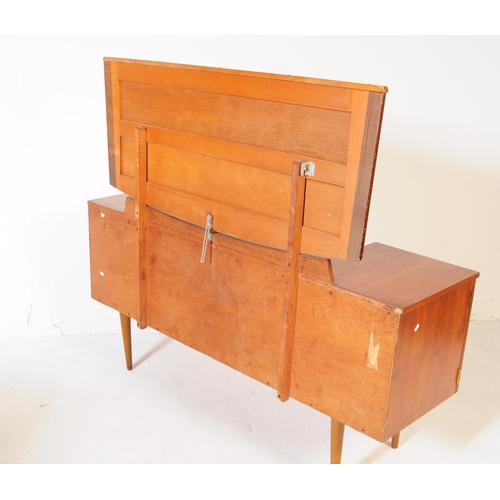 611 - Lebus - A mid 20th century Lebus teak wood dressing table. The dresser of inverse breakfront form, w... 