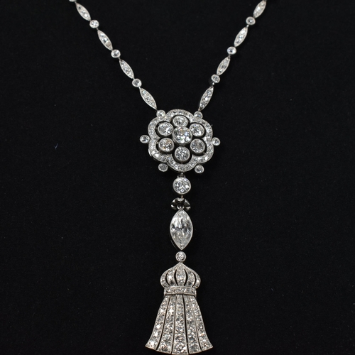 1 - A cased Edwardian platinum and diamond pendant necklace. The necklace strung with an articulating ta... 