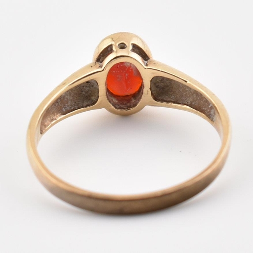 101 - A hallmarked 9ct yellow gold & garnet solitaire ring. The single stone ring having an oval cut bezel... 