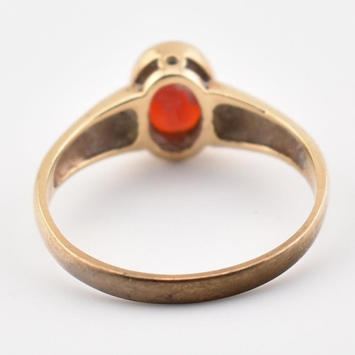 101 - A hallmarked 9ct yellow gold & garnet solitaire ring. The single stone ring having an oval cut bezel... 