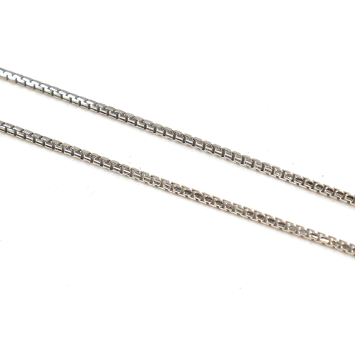 11 - An 18ct white gold and diamond pendant necklace. The 18ct white gold box chain necklace strung with ... 