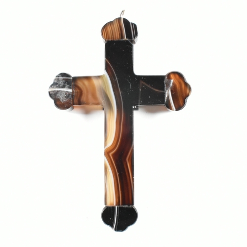 110 - A French carved banded agate cross pendant. The cross having a fluted body, to carved finials, with ... 