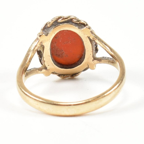 114 - A hallmarked 9ct gold and carnelian ring. The ring set with a carnelian cabochon framed with a rope ... 