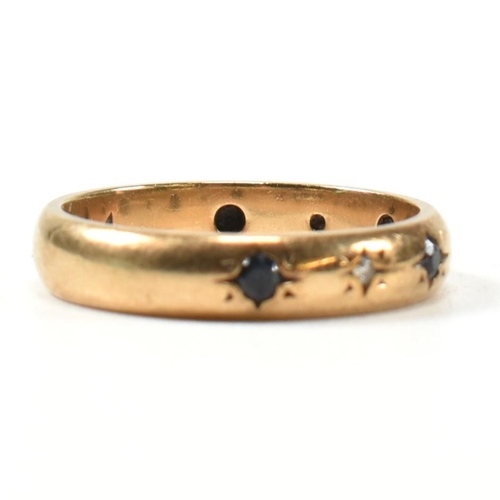 115 - A hallmarked 9ct gold, sapphire and diamond band ring. The gold band ring set with four star set rou... 