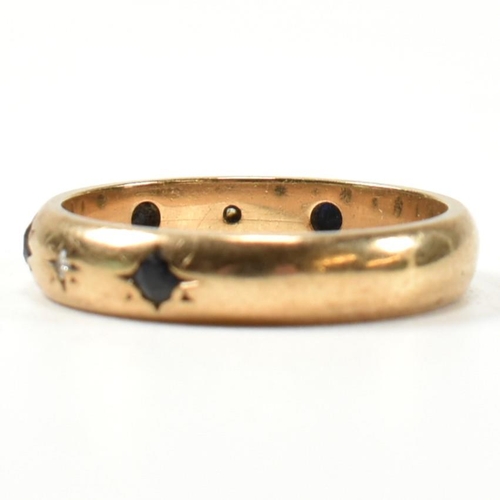 115 - A hallmarked 9ct gold, sapphire and diamond band ring. The gold band ring set with four star set rou... 