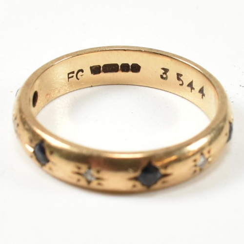 115 - A hallmarked 9ct gold, sapphire and diamond band ring. The gold band ring set with four star set rou... 