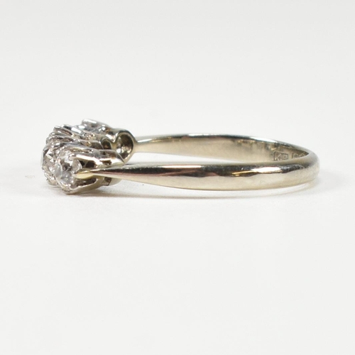 116 - An 18ct white gold and platinum diamond five stone ring. The ring set with five old cut diamonds to ... 