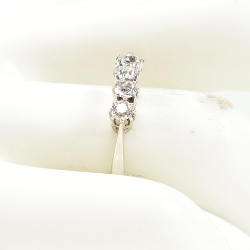 116 - An 18ct white gold and platinum diamond five stone ring. The ring set with five old cut diamonds to ... 