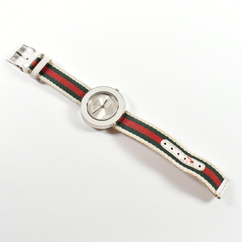 117 - Gucci U-Play wrist watch. The wrist watch having silver face with interchangeable straps and dust po... 