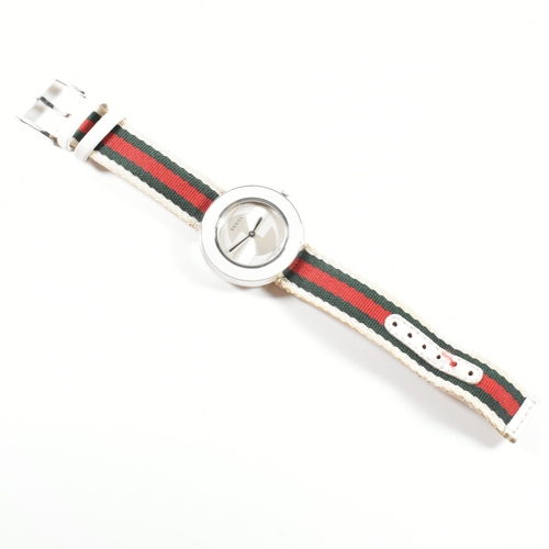 117 - Gucci U-Play wrist watch. The wrist watch having silver face with interchangeable straps and dust po... 