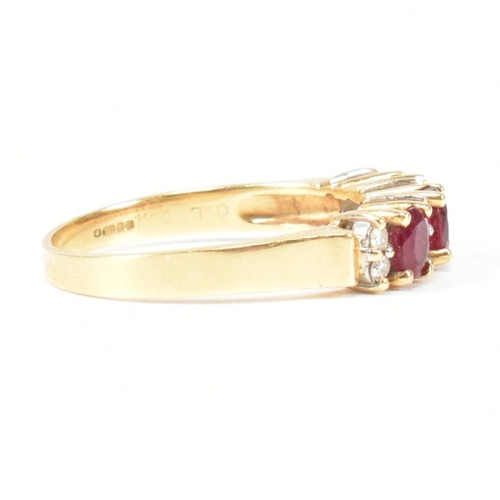 120 - A hallmarked 18ct gold ruby and diamond three stone ring. The ring having three button prong set ova... 