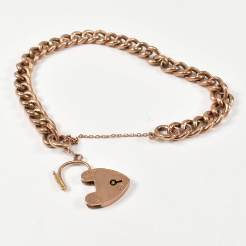 121 - A 9ct rose gold heart padlock and curb link chain bracelet. The hallmarked 9ct gold curb link bracel... 