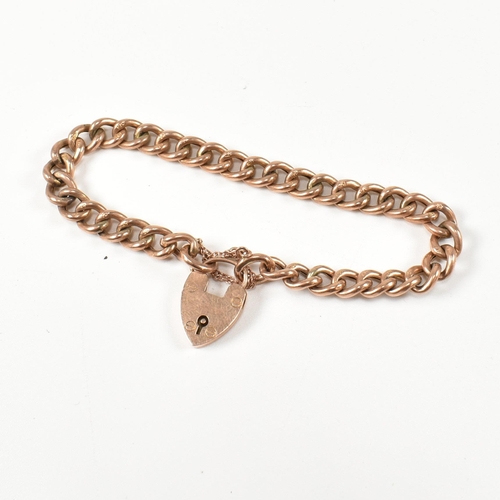 121 - A 9ct rose gold heart padlock and curb link chain bracelet. The hallmarked 9ct gold curb link bracel... 