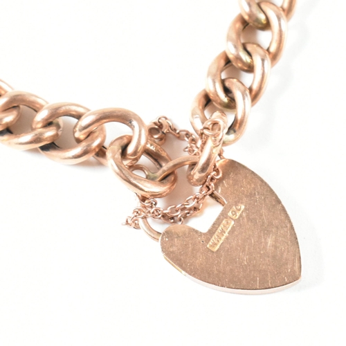 121 - A 9ct rose gold heart padlock and curb link chain bracelet. The hallmarked 9ct gold curb link bracel... 