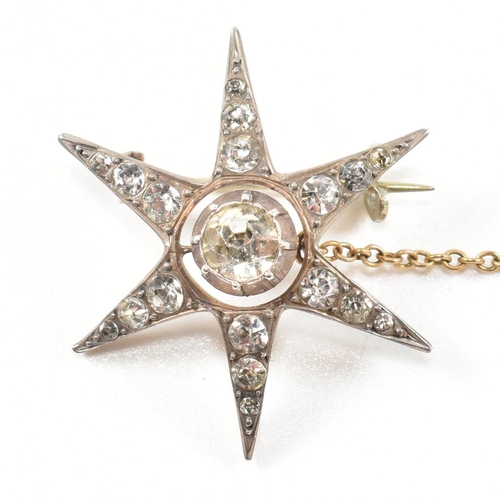 143 - An antique silver and paste star brooch pin. The brooch in the form of an eight pointed star set wit... 