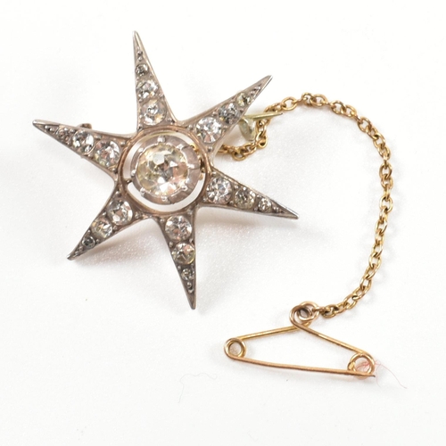 143 - An antique silver and paste star brooch pin. The brooch in the form of an eight pointed star set wit... 