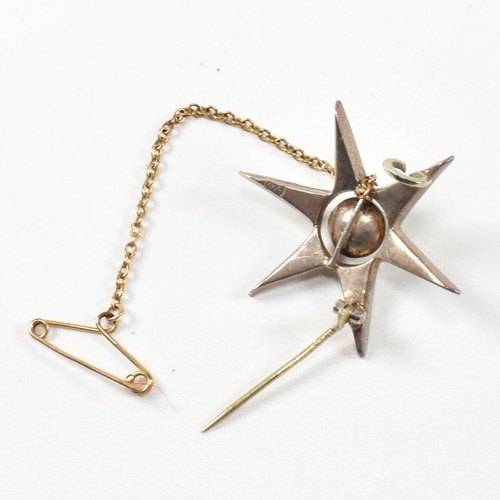 143 - An antique silver and paste star brooch pin. The brooch in the form of an eight pointed star set wit... 