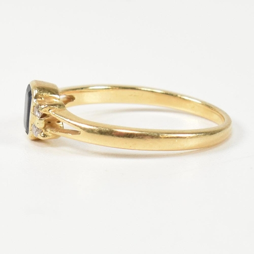 144 - An 18ct gold sapphire and diamond ring. The ring having a central bezel set emerald cut sapphire fla... 