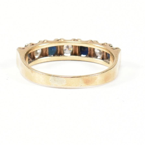 151 - A hallmarked 9ct gold, sapphire and CZ half hoop ring. The ring set with four round cut sapphires in... 