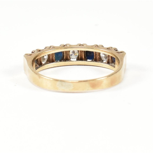 151 - A hallmarked 9ct gold, sapphire and CZ half hoop ring. The ring set with four round cut sapphires in... 