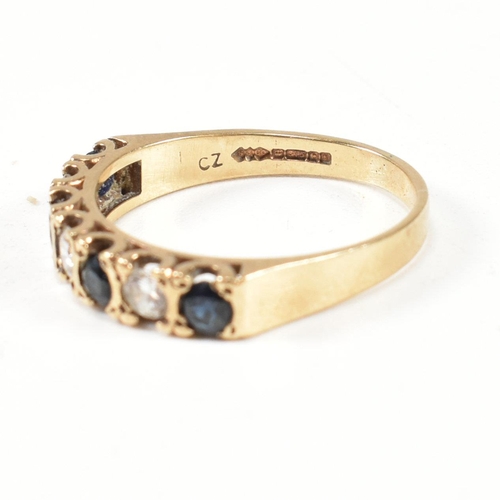 151 - A hallmarked 9ct gold, sapphire and CZ half hoop ring. The ring set with four round cut sapphires in... 