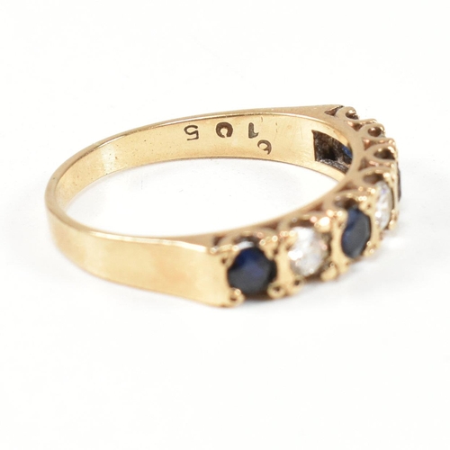 151 - A hallmarked 9ct gold, sapphire and CZ half hoop ring. The ring set with four round cut sapphires in... 