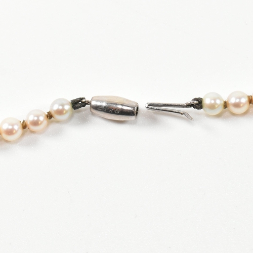 153 - A 9ct white gold and cultured pearl necklace. The single strand necklace strung with ninety five gra... 