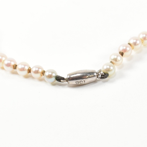 153 - A 9ct white gold and cultured pearl necklace. The single strand necklace strung with ninety five gra... 