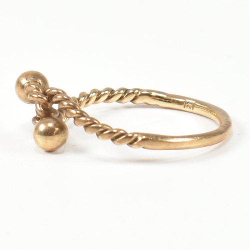 160 - A hallmarked 9ct gold rope twist ring. The ring having a twisted rope design with two metalwork bead... 