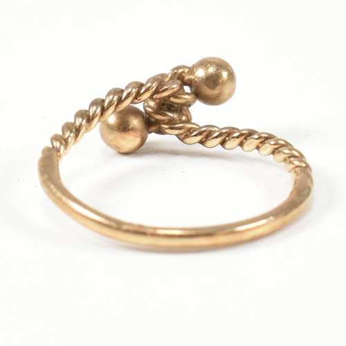 160 - A hallmarked 9ct gold rope twist ring. The ring having a twisted rope design with two metalwork bead... 