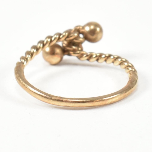 160 - A hallmarked 9ct gold rope twist ring. The ring having a twisted rope design with two metalwork bead... 