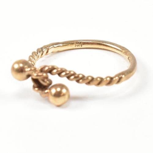 160 - A hallmarked 9ct gold rope twist ring. The ring having a twisted rope design with two metalwork bead... 