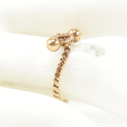 160 - A hallmarked 9ct gold rope twist ring. The ring having a twisted rope design with two metalwork bead... 