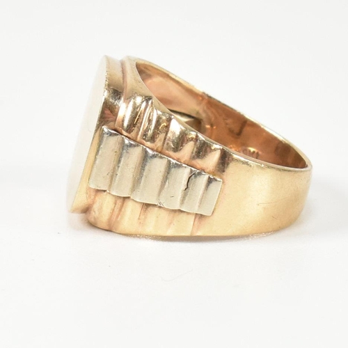 166 - A hallmarked 9ct gold watch strap signet ring. The gold signet ring having a cushion shaped face to ... 