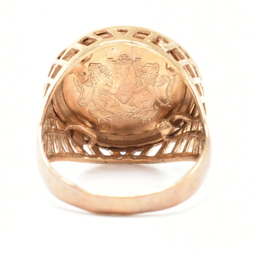 169 - A hallmarked 9ct gold faux sovereign signet ring. The ring set with a faux sovereign in a hallmarked... 