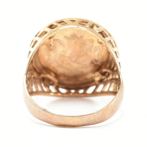 169 - A hallmarked 9ct gold faux sovereign signet ring. The ring set with a faux sovereign in a hallmarked... 