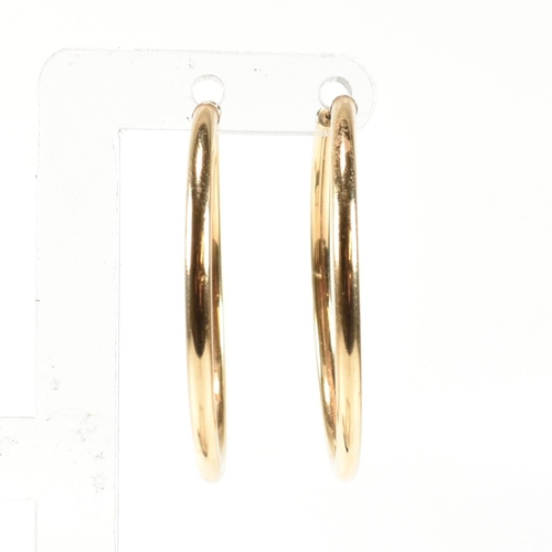 176 - A pair of hallmarked 9ct gold hoop earrings. The 9ct gold earrings having endless style fasteners. H... 