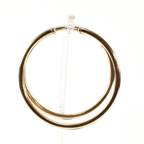 176 - A pair of hallmarked 9ct gold hoop earrings. The 9ct gold earrings having endless style fasteners. H... 