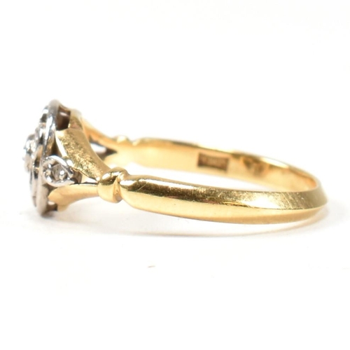 18 - An 18ct gold and diamond cluster ring. The ring having a central bezel set round brilliant cut diamo... 