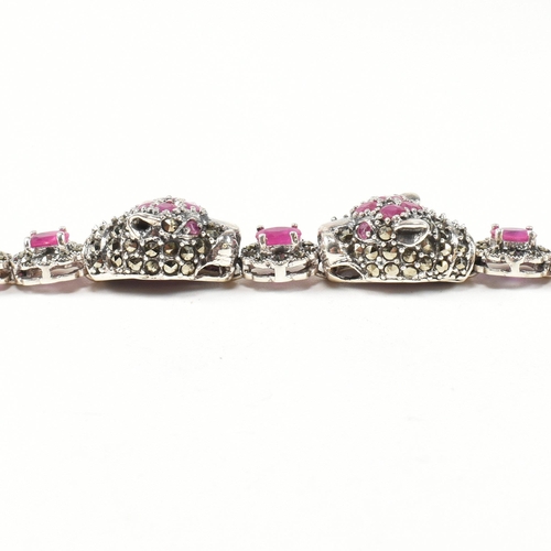 189 - A 925 silver, marcasite and ruby set double panther head bracelet. The silver bracelet having two pa... 