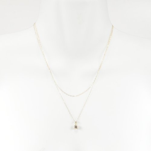 192 - Three 9ct gold, diamond and gem set chain necklaces. The gold necklaces to include a 9ct gold pendan... 