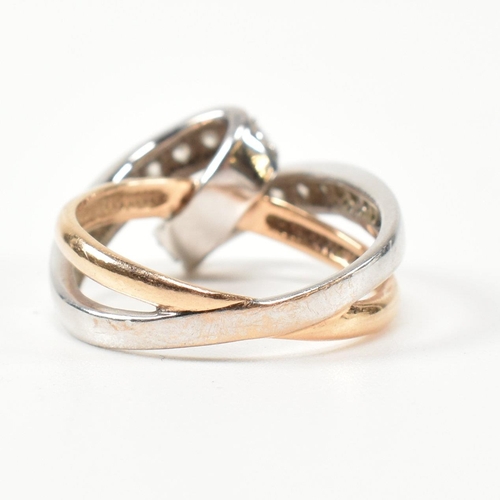 193 - A 14ct white and rose gold and CZ set twist ring. The intertwined multi-tone ring having a white gol... 