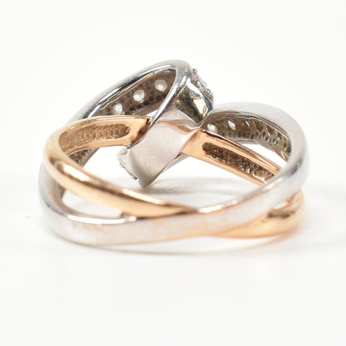 193 - A 14ct white and rose gold and CZ set twist ring. The intertwined multi-tone ring having a white gol... 