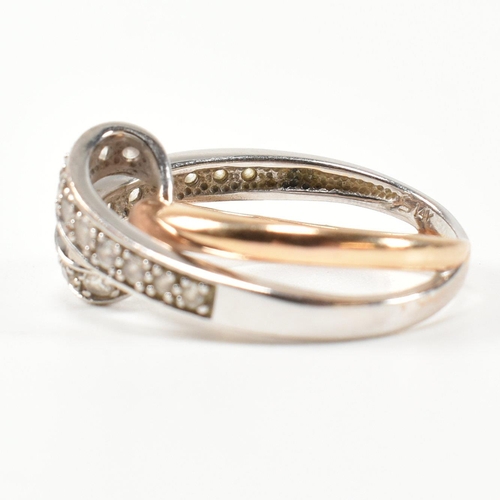 193 - A 14ct white and rose gold and CZ set twist ring. The intertwined multi-tone ring having a white gol... 