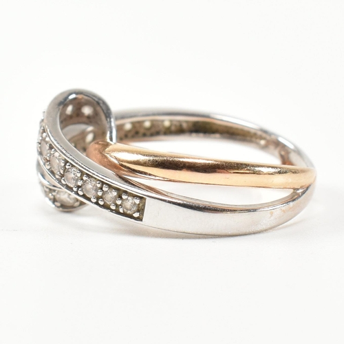 193 - A 14ct white and rose gold and CZ set twist ring. The intertwined multi-tone ring having a white gol... 