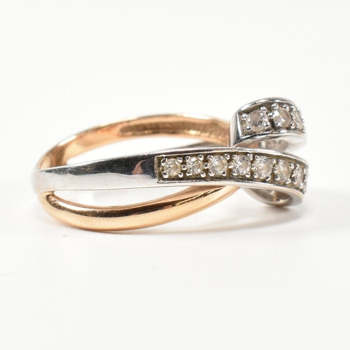 193 - A 14ct white and rose gold and CZ set twist ring. The intertwined multi-tone ring having a white gol... 