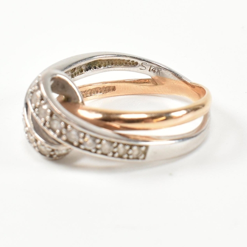 193 - A 14ct white and rose gold and CZ set twist ring. The intertwined multi-tone ring having a white gol... 