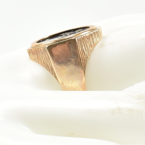 195 - A hallmarked 9ct gold signet ring having an onyx plaque with incised gilded cannabis leaf motif havi... 