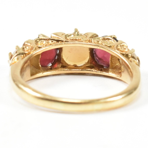 20 - A gold pearl and garnet and diamond five stone ring. The ring set with three half pearls and two rou... 