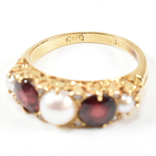 20 - A gold pearl and garnet and diamond five stone ring. The ring set with three half pearls and two rou... 